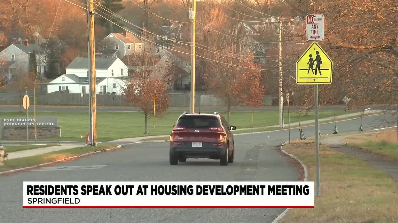 Residents rally to meeting to protest housing project