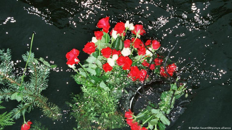 Flowers accompany a deceased's ashes scattered at sea