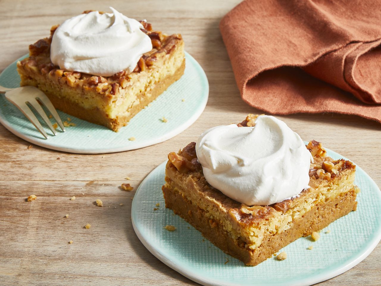 close up view of slices of Great Pumpkin Dessert garnished with cream on plates