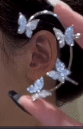 Close-up of an ear adorned with a sparkling butterfly-themed ear cuff