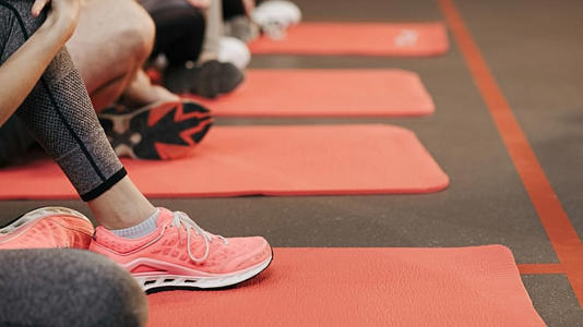 People are shown at an exercise class.