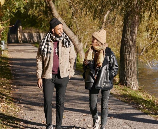 Man and woman walking in autumn park