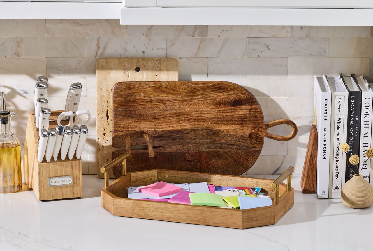 Paper clutter on kitchen countertop