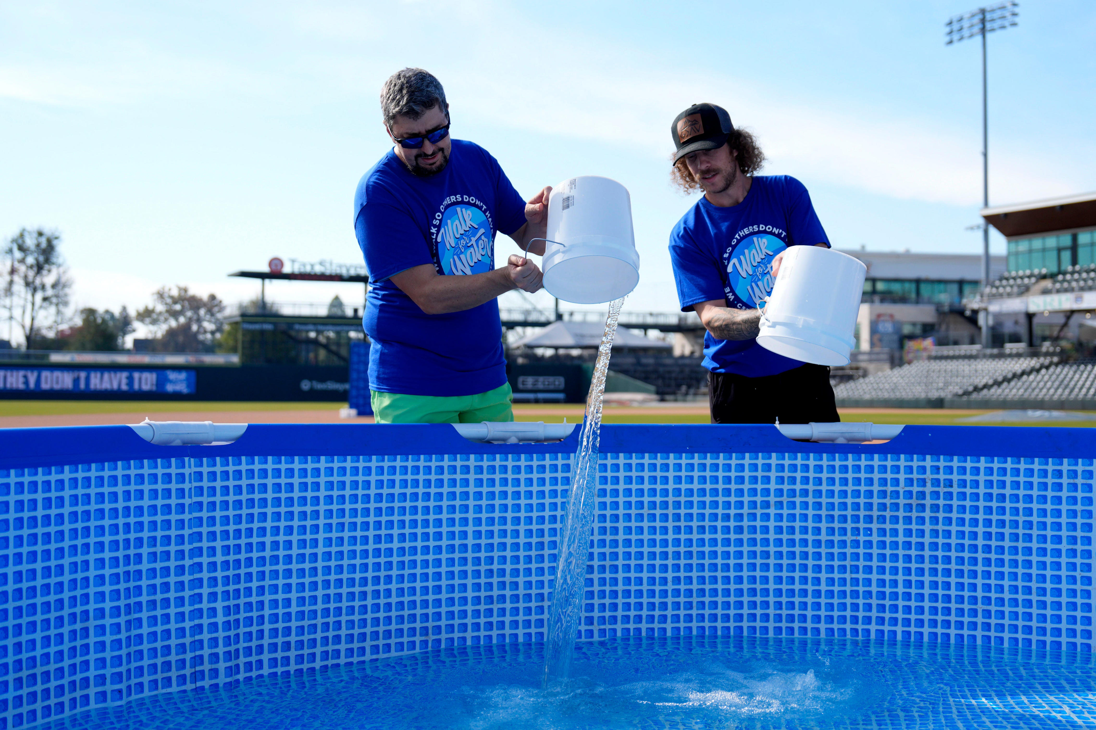 Participants carry buckets of water 3 miles to fundraise for Water ...