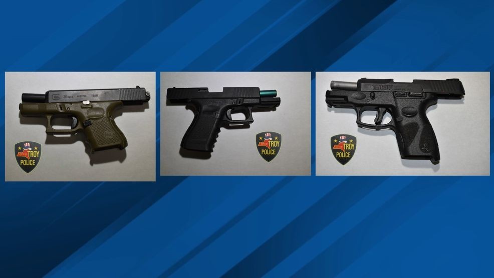 Four people charged in Troy gun bust