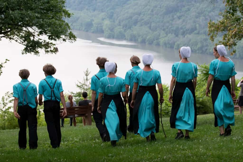 Amish men and women walking near a river. Image credits: Kia Sari/Unsplash