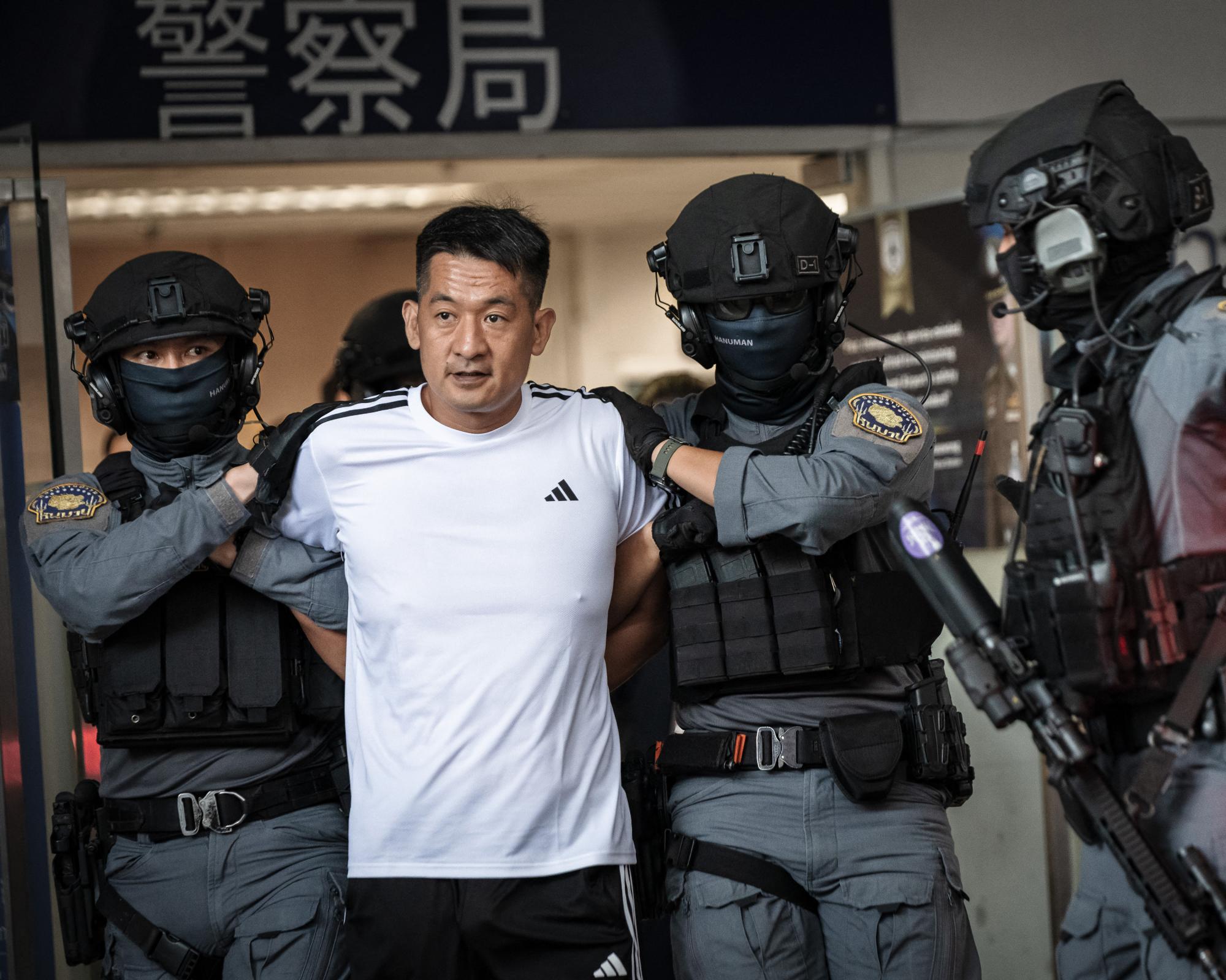 Chinese businessman She Zhijiang is escorted by Royal Thai police as he prepares to be extradited from Thailand to China. Photograph: Chanakarn Laosarakham/AFP/Getty Images
