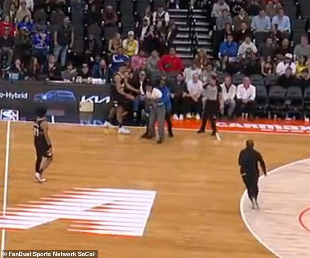 Wild moment NBA fan sprints onto the court midgame and evades multiple ...