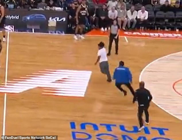 Wild moment NBA fan sprints onto the court midgame and evades multiple ...