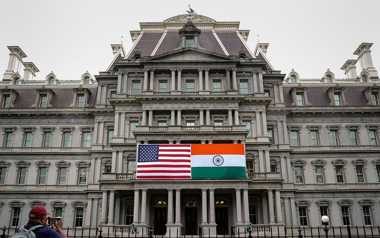 The flags of the United States and India are displayed