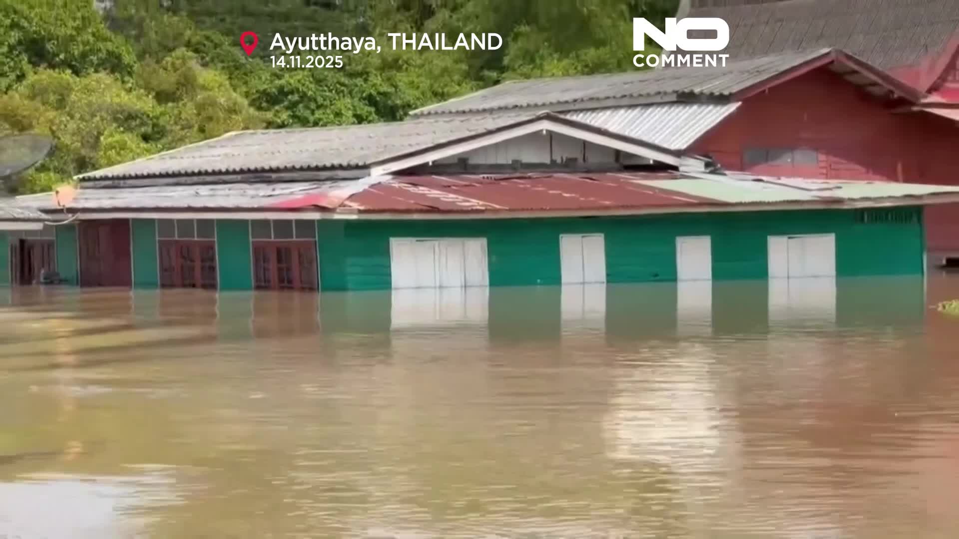 Flooding forces Thai man to live on his roof for weeks