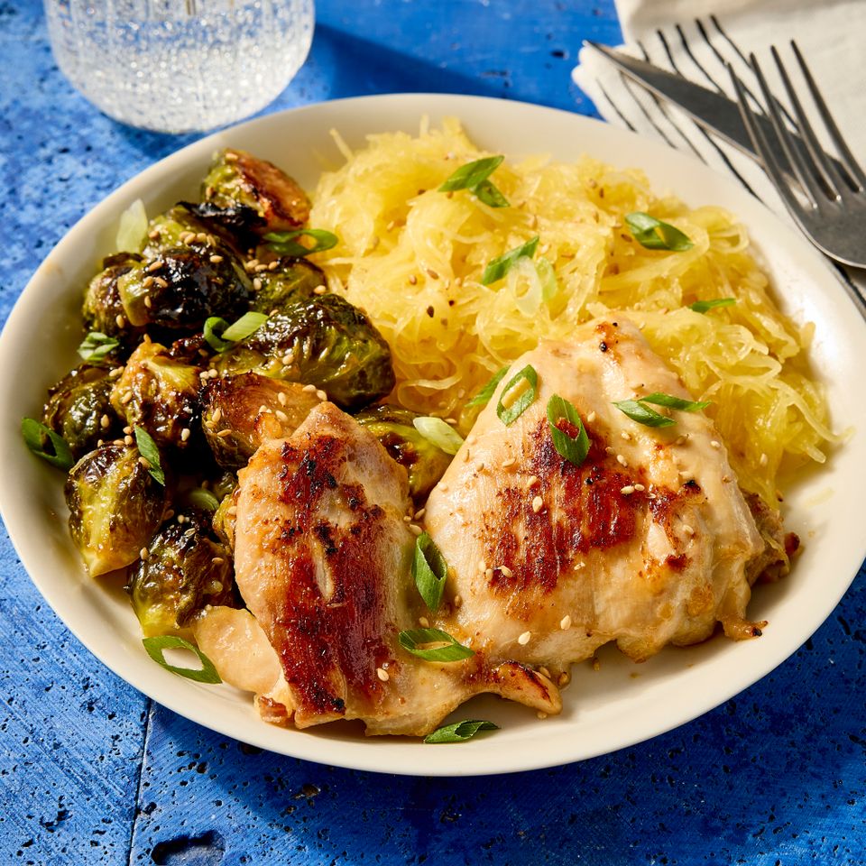 A recipe image of Maple-Miso Chicken Thighs, Brussels Sprouts & Spaghetti Squash.