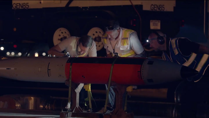 US Air Force and Energy Department personnel load unarmed nuclear bombs ...