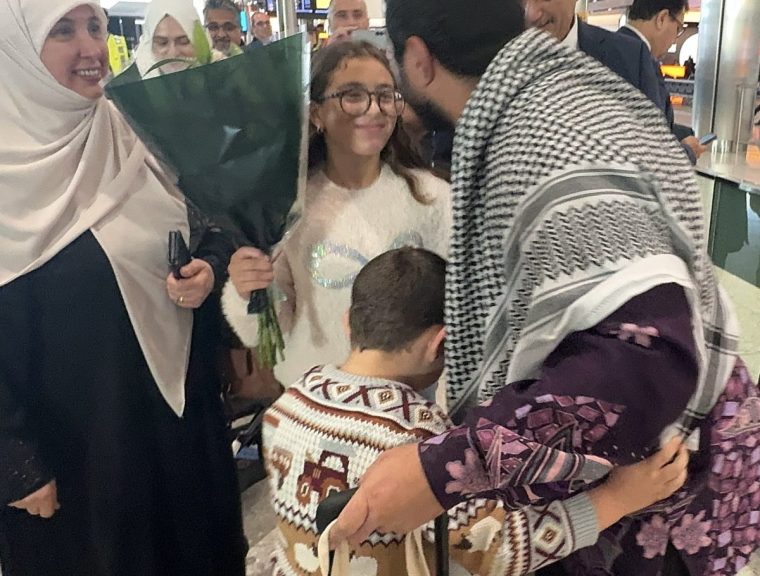 Hamdi (right), being greeted by family members at Heathrow Airport (Photo: Free Sami Hamdi campaign/PA)