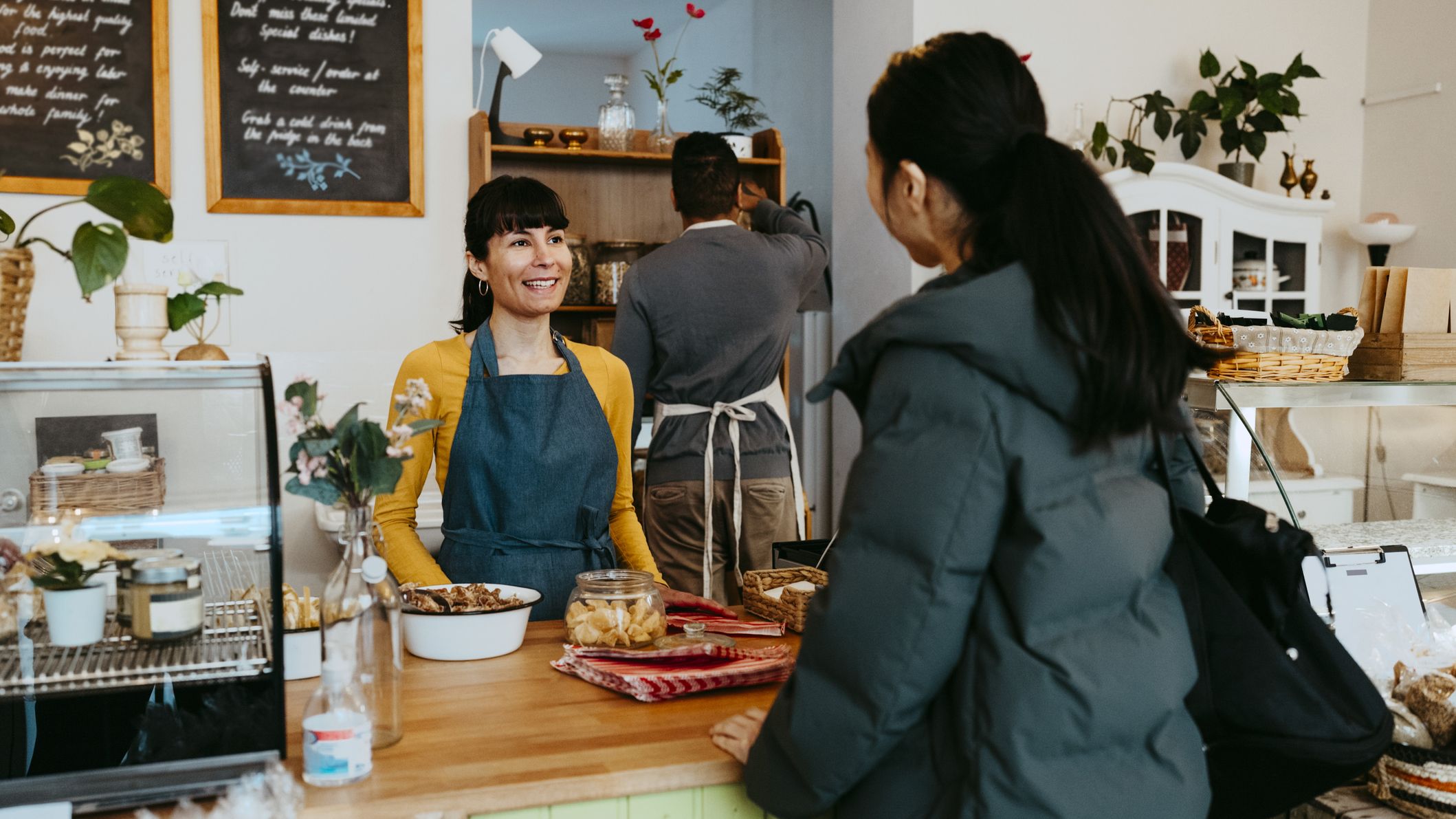 Woman ordering coffee from a barista