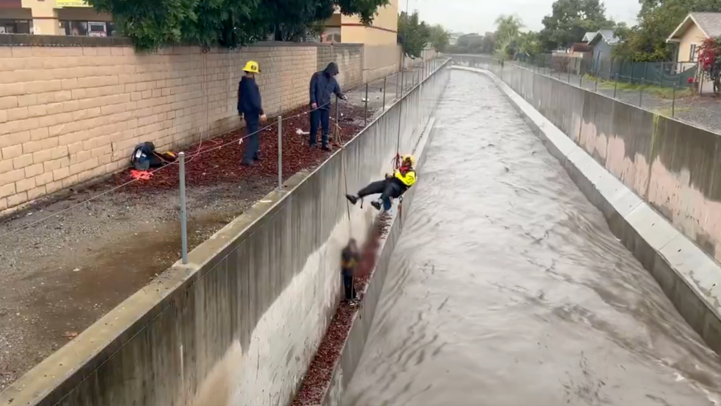 Video shows Orange County firefighters rescuing man trapped above ...