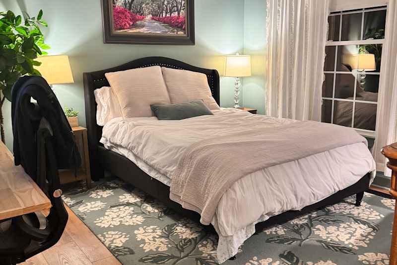 bed made in guest bedroom