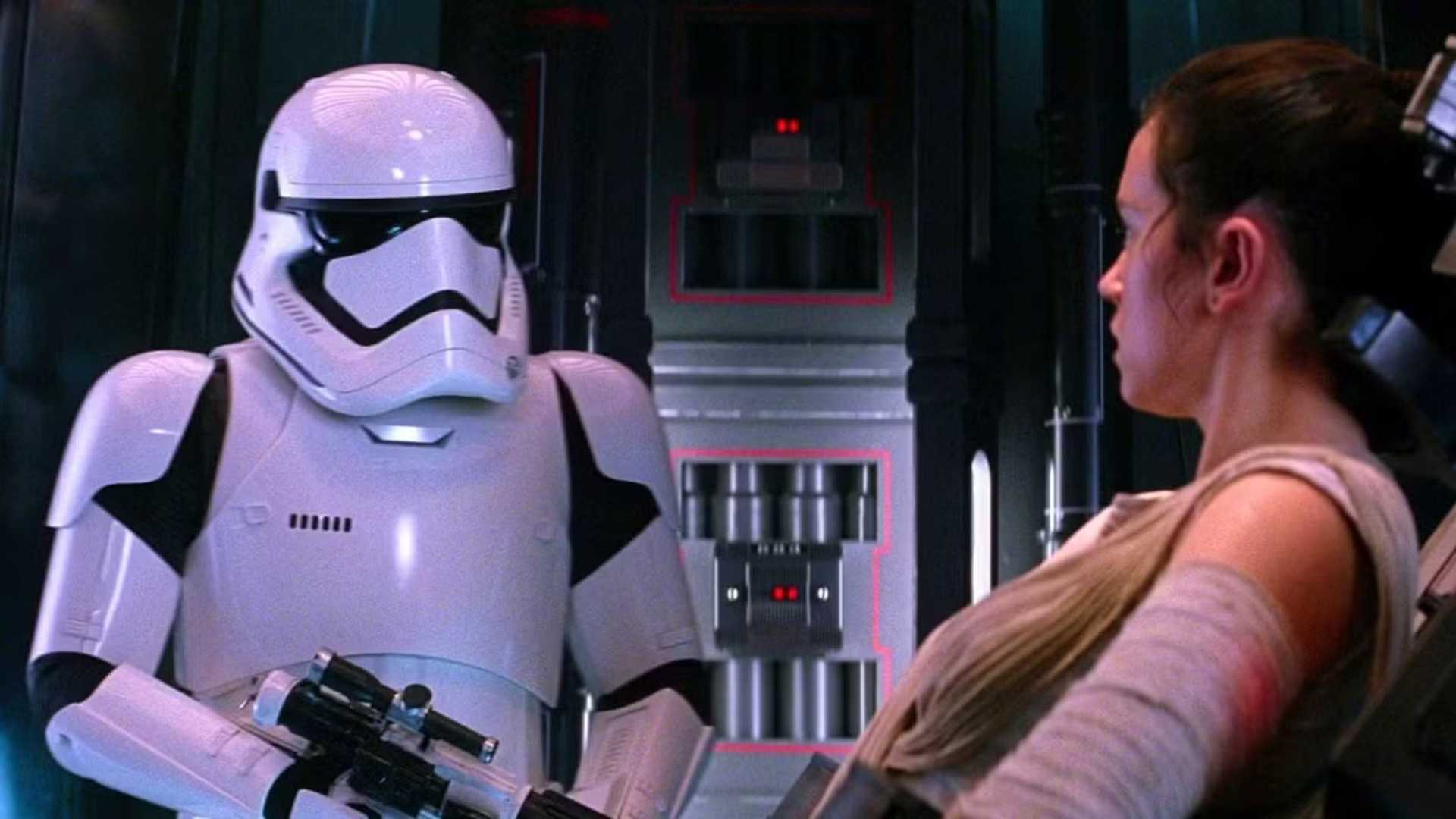 Daniel Craig as a stormtrooper looking at a captive Rey in The Force Awakens
