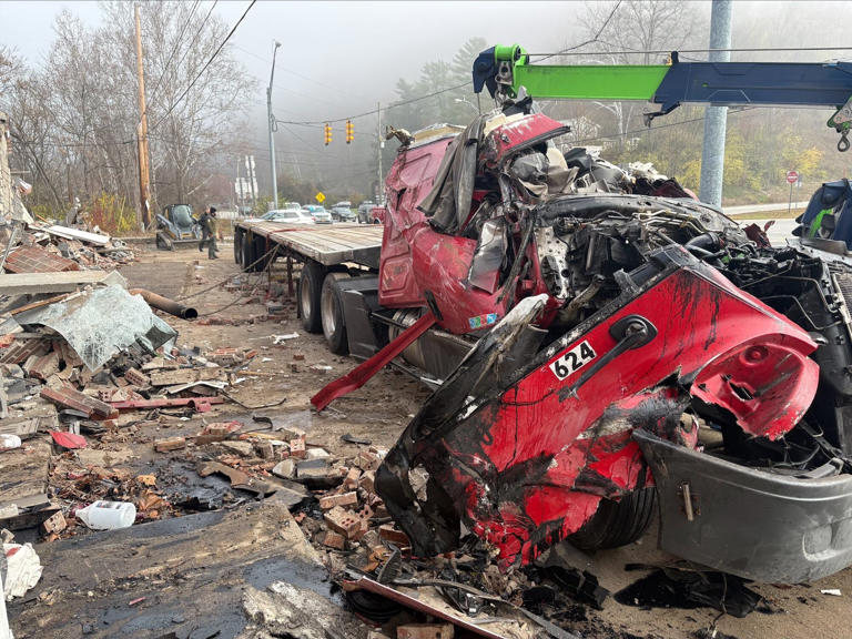 Truck crashes into building; driver rescued