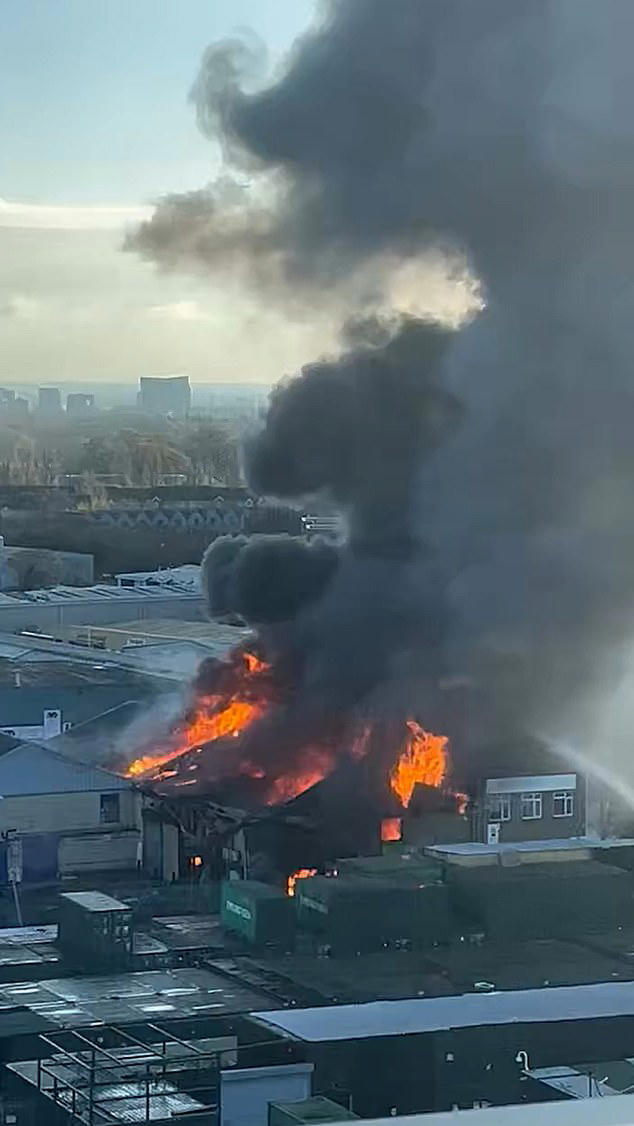 Huge fire tears through warehouse as 150 firefighters rush to fight blaze