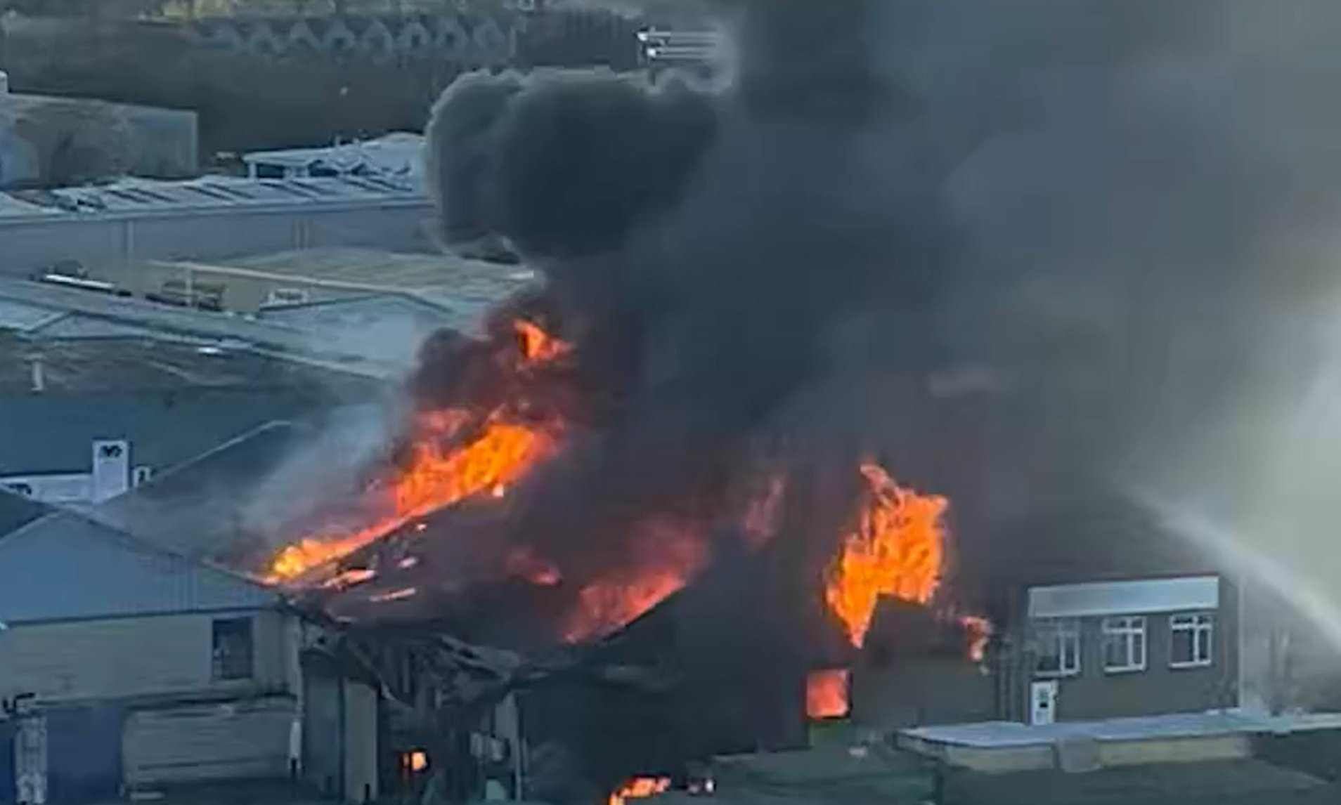 Huge fire tears through warehouse as 150 firefighters rush to fight blaze