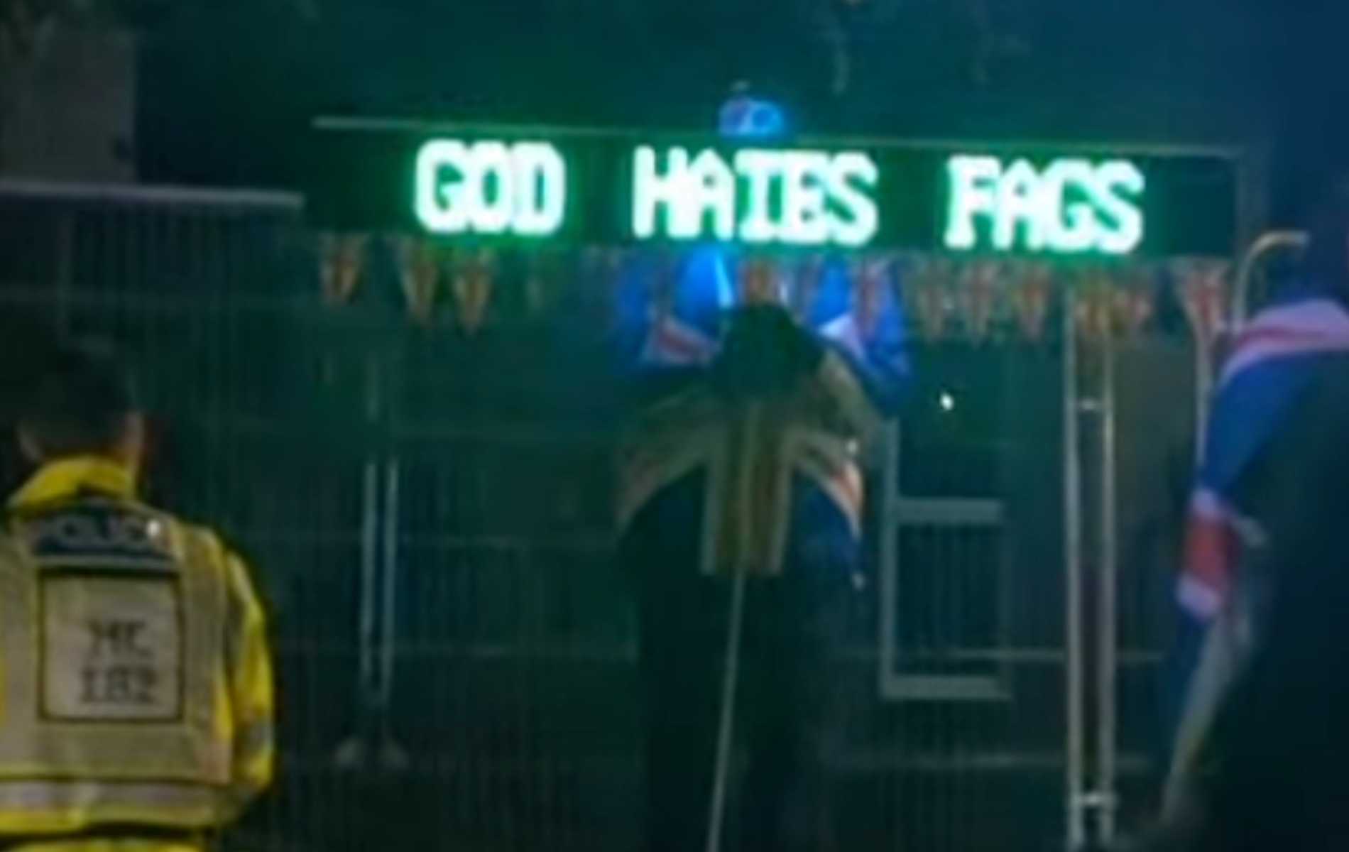 Man arrested after allegedly displaying homophobic sign at anti ...