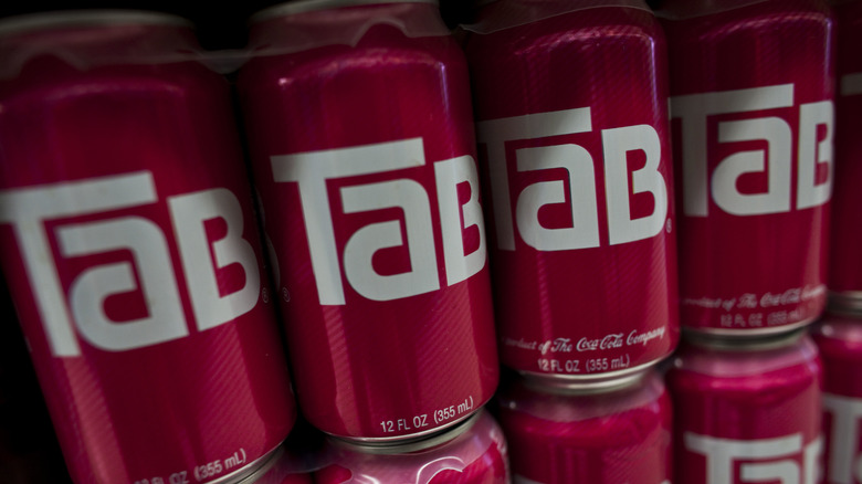 Red cans of Tab soda in a stack
