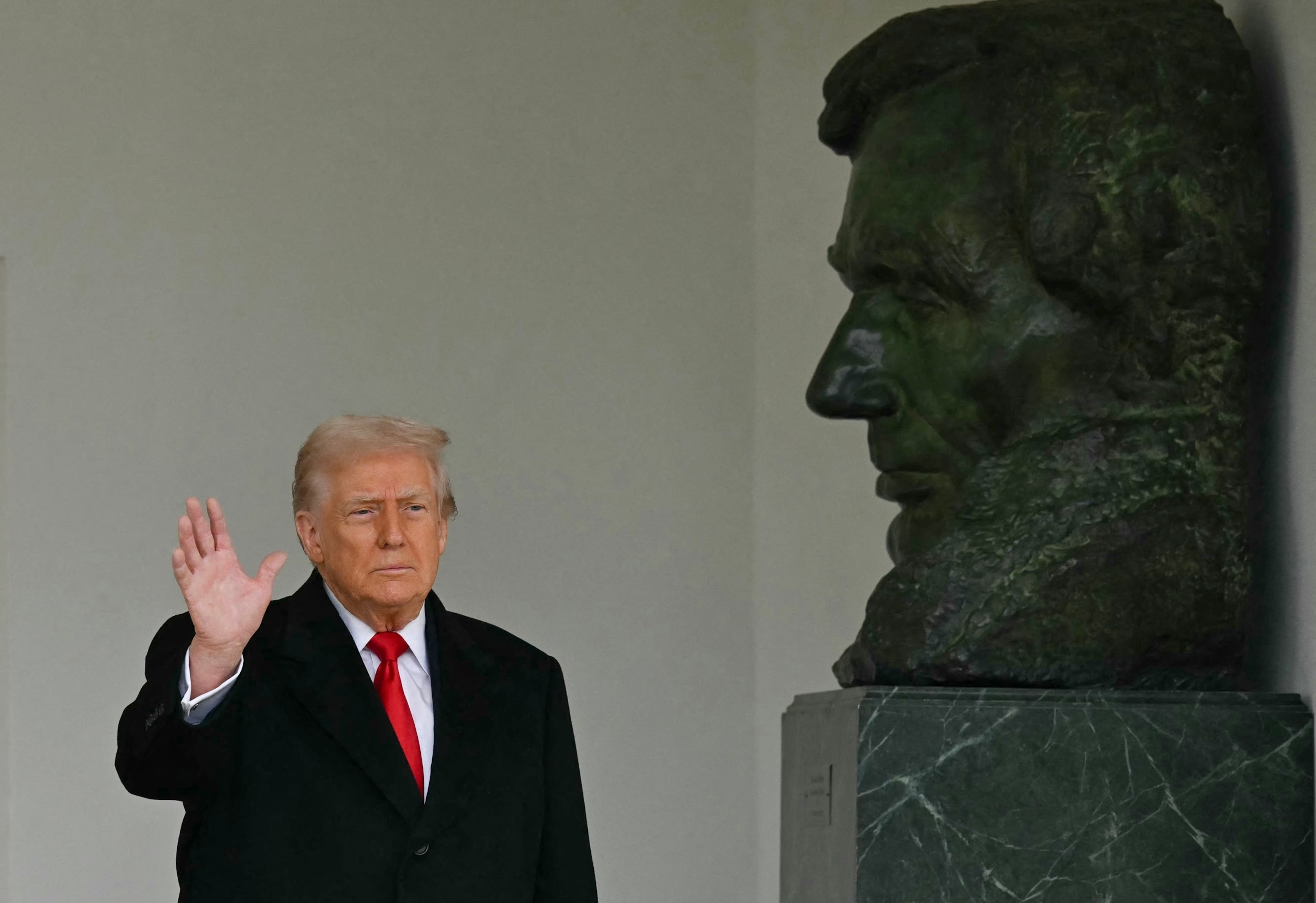 Andrew Caballero-Reynolds/AFP via Getty Images - PHOTO: President Donald Trump stands beside a statue of President Abraham Lincoln as he waves after participating in the White House turkey pardon ceremony in the Rose Garden of the White House in Washington, November 25, 2025.