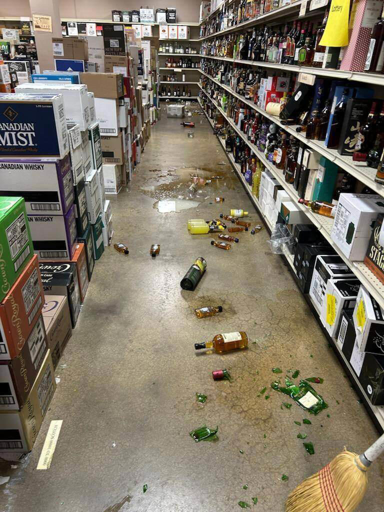 The trash panda had targeted the bottom shelf, home to scotch and whisky, leaving a trail of destruction. (Samantha Martin/Hanover County Protection via AP)