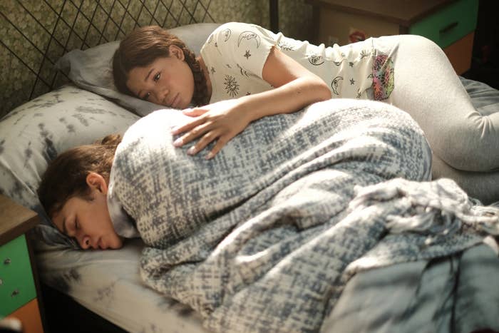 "Euphoria" scene: Gia with a comforting hand over a passed out Rue in bed with blankets