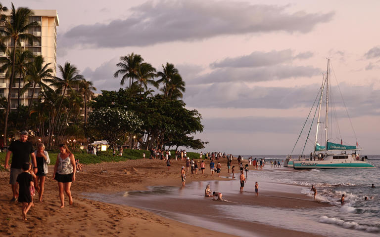 LAHAINA, HAWAII - AUGUST 05: People gather on Kaanapali Beach, a popular tourist destination, on August 5, 2024 near Lahaina, Hawaii.