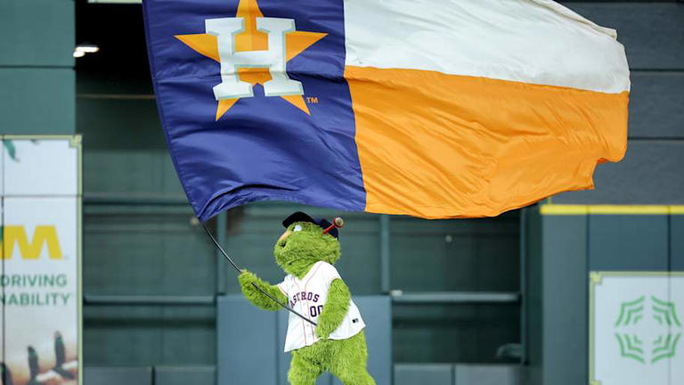 May 22, 2025; Houston, Texas, USA; Houston Astros mascot Orbit waves a flag in center field after the final out against the Seattle Mariners during the ninth inning at Daikin Park. Mandatory Credit: Erik Williams-Imagn Images | Erik Williams-Imagn Images