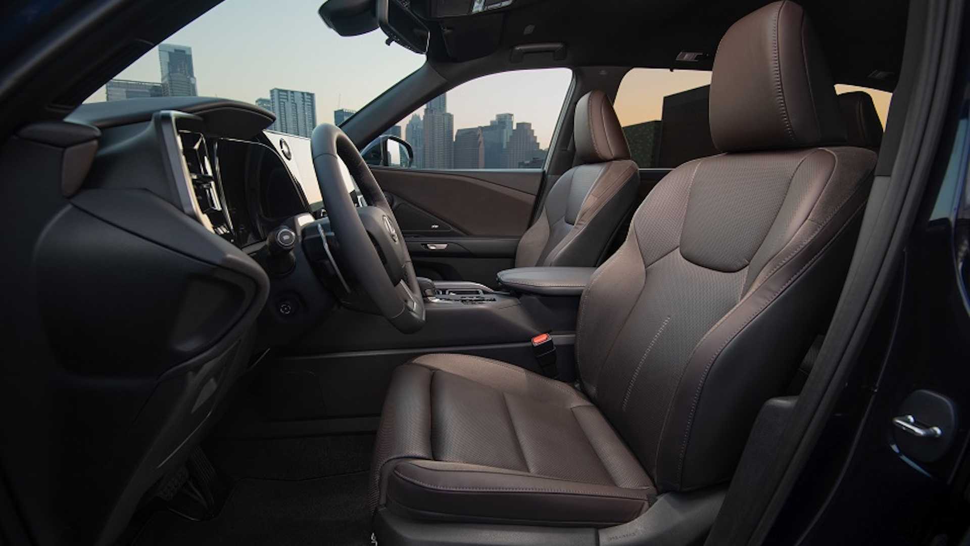 2024 Lexus TX 550h+ driver side front row with brown leather seats
