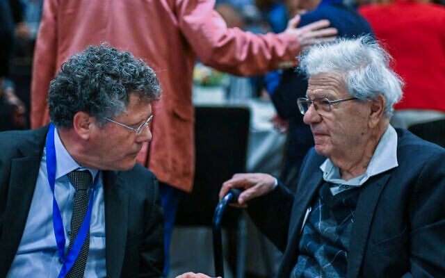 Supreme Court President Isaac Amit (left) speaks with retired justice Aharon Barak during a conference of the Israeli Association of Public Law (IAPL) in Haifa, December 4, 2025. (Flash90)