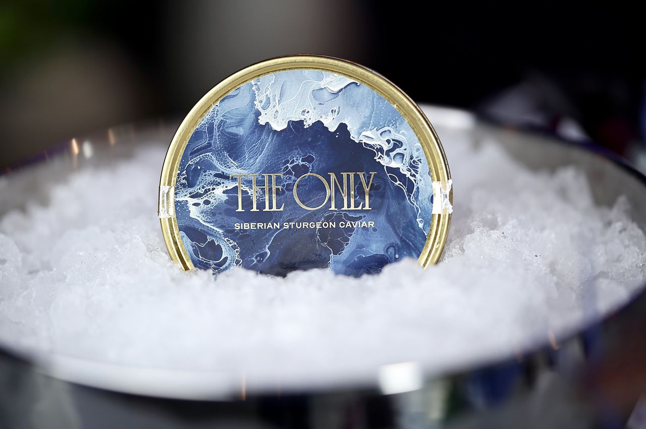 A tin of Siberian sturgeon caviar labeled The Only displayed on a bed of ice