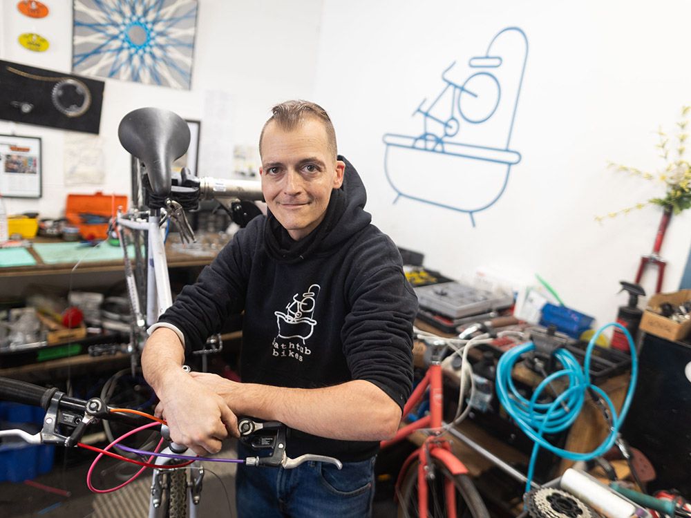 Owner of Bathtub Bikes celebrates new business sign after five-year wait
