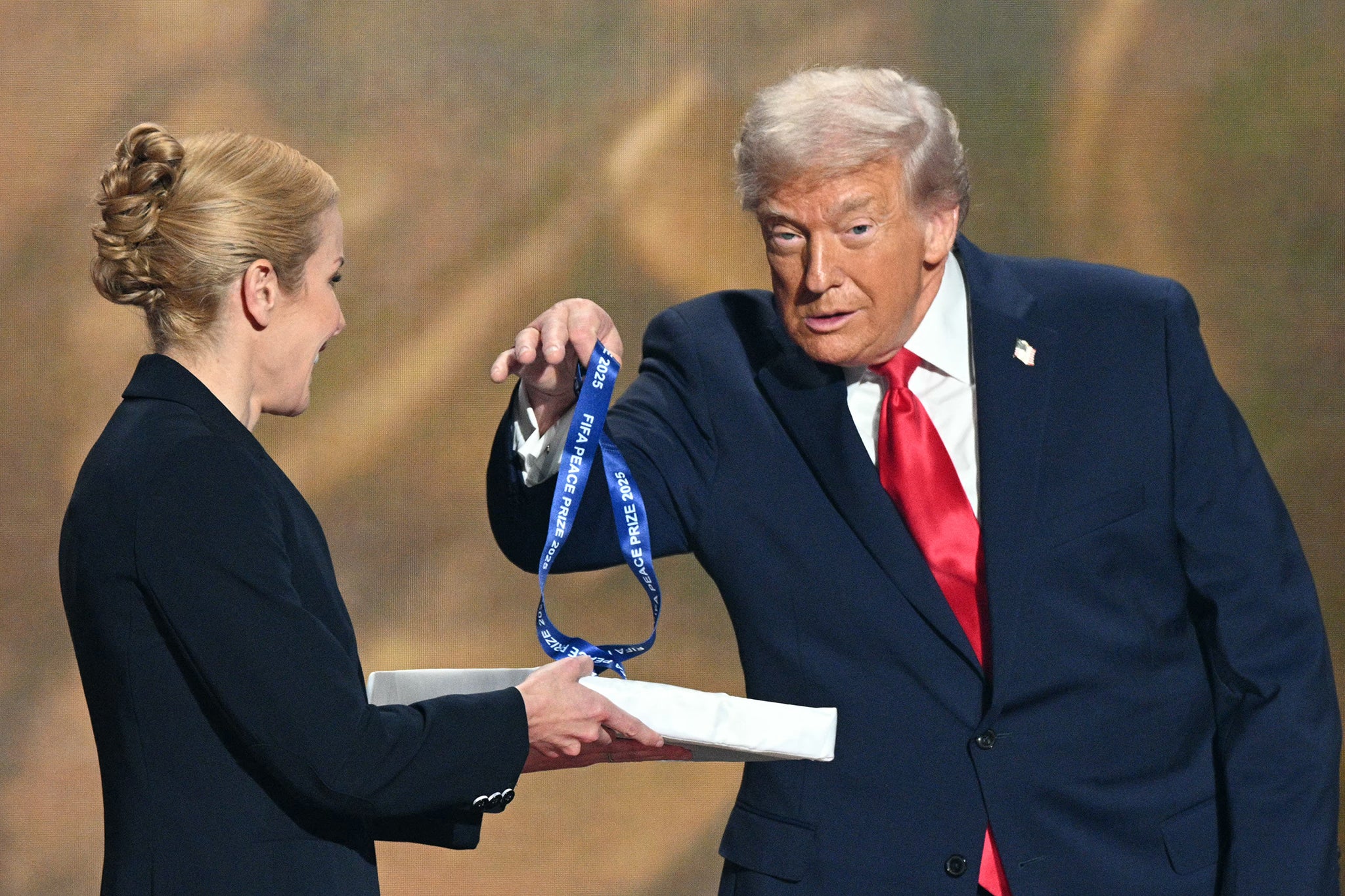 Donald Trump holds a medal as he receives the FIFA Peace Prize (AFP/Getty)