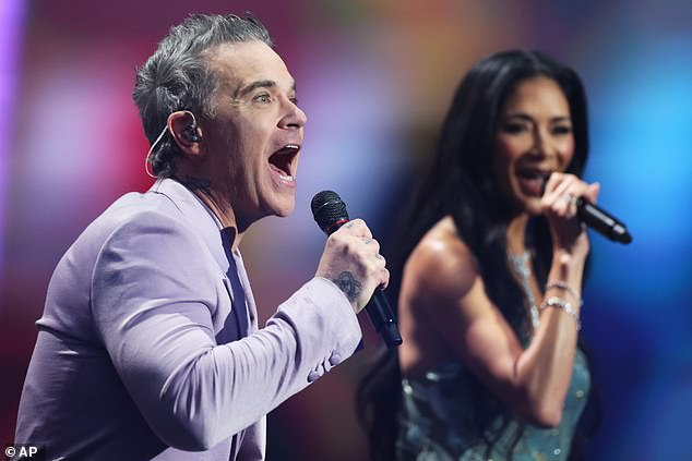 Robbie could also be seen treating the crowd to a performance as she duetted with Pussycat Doll's Nicole Scherzinger