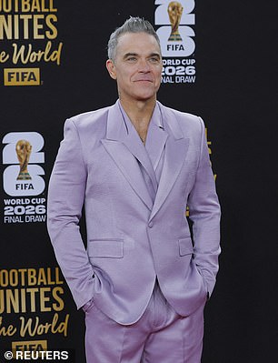 Robbie wore his salt and pepper locks in spikes as he completed the look with a pair of shiny black dress shoes