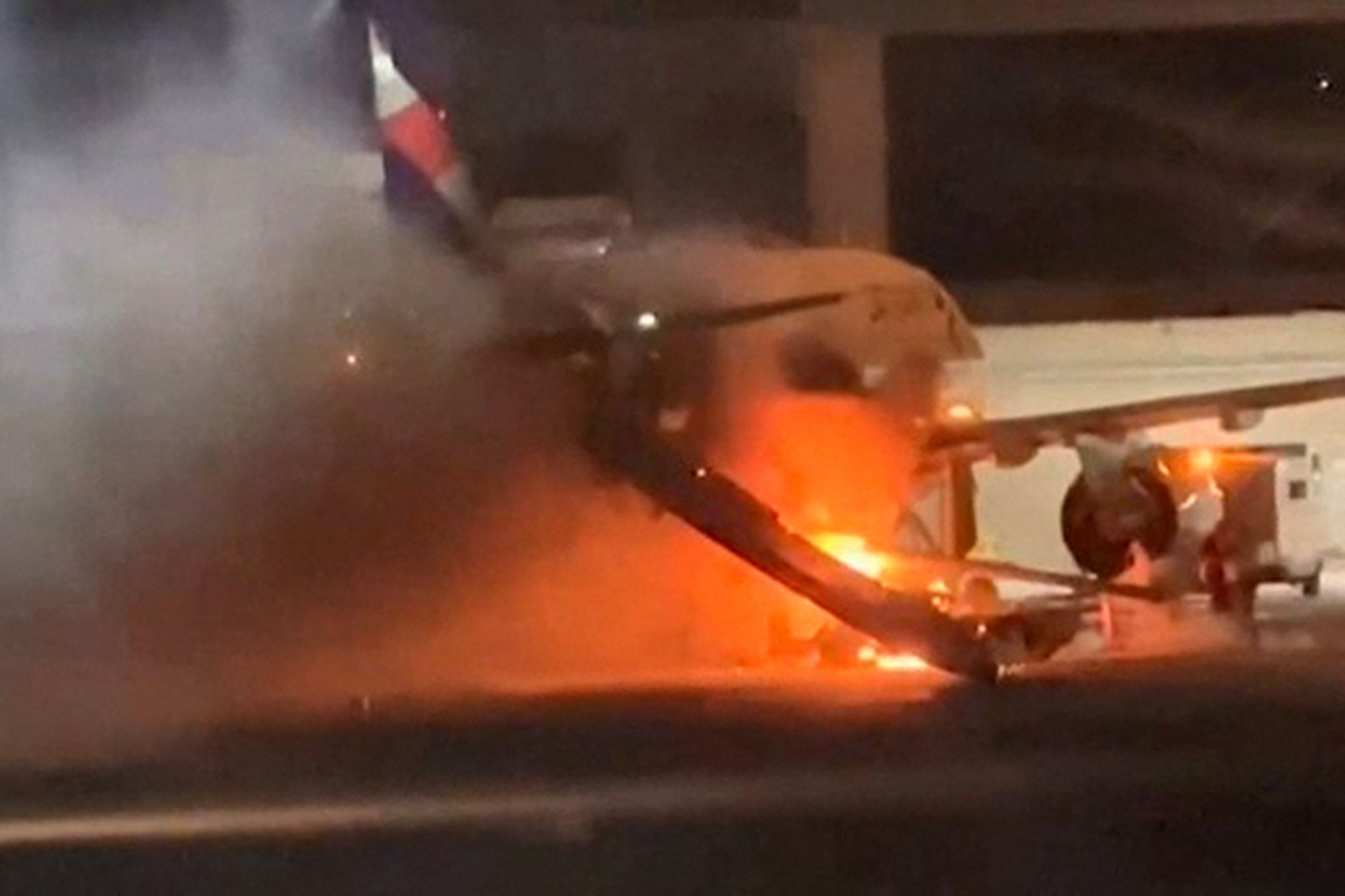 169 panicked passengers escape plane after airport fire caused cabin to ...
