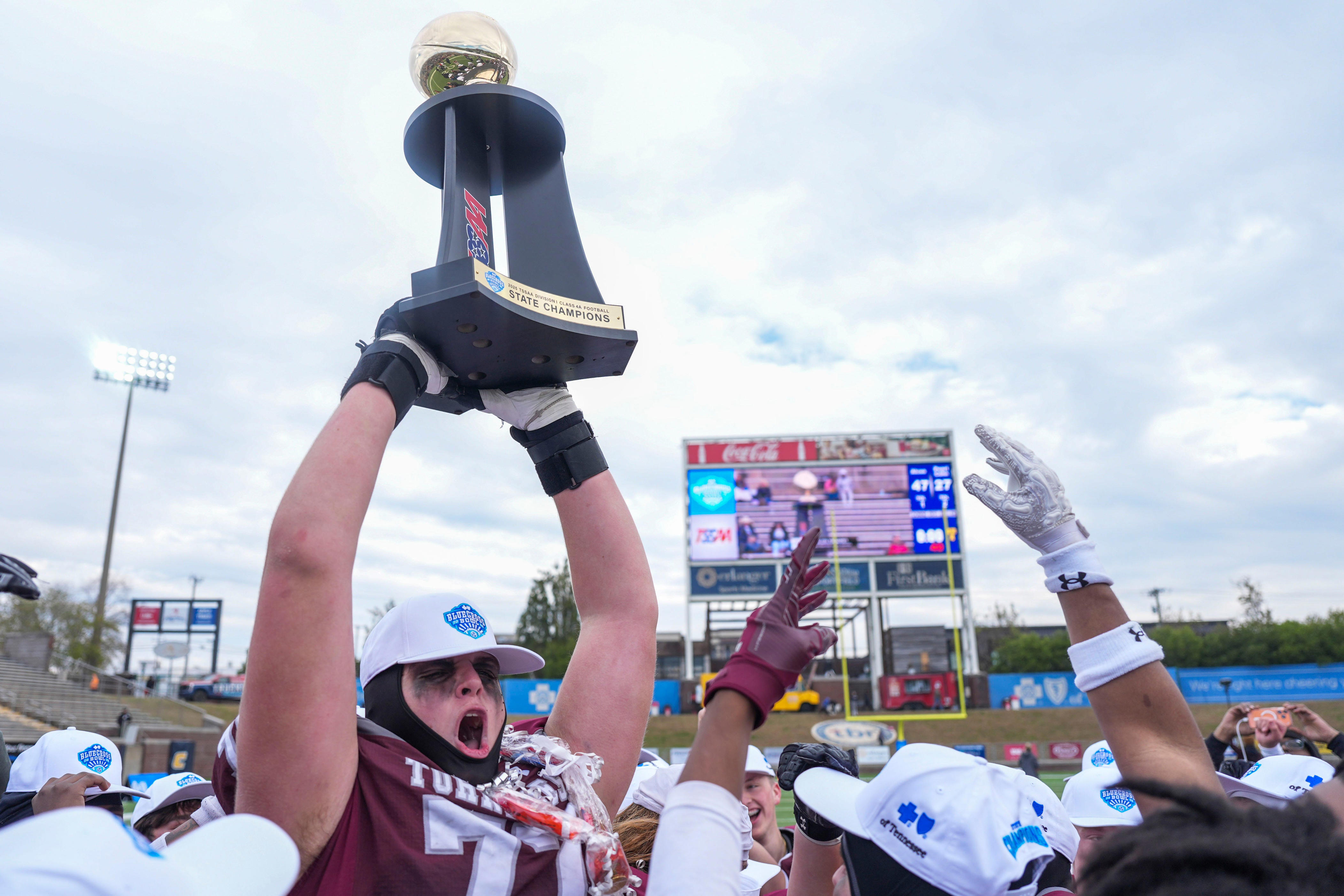 Alcoa's Jacob Crow (77) holds up the championship trophy after the Class 4A championship game at Finley Stadium in Chattanooga, Tenn., on Dec. 6, 2025.