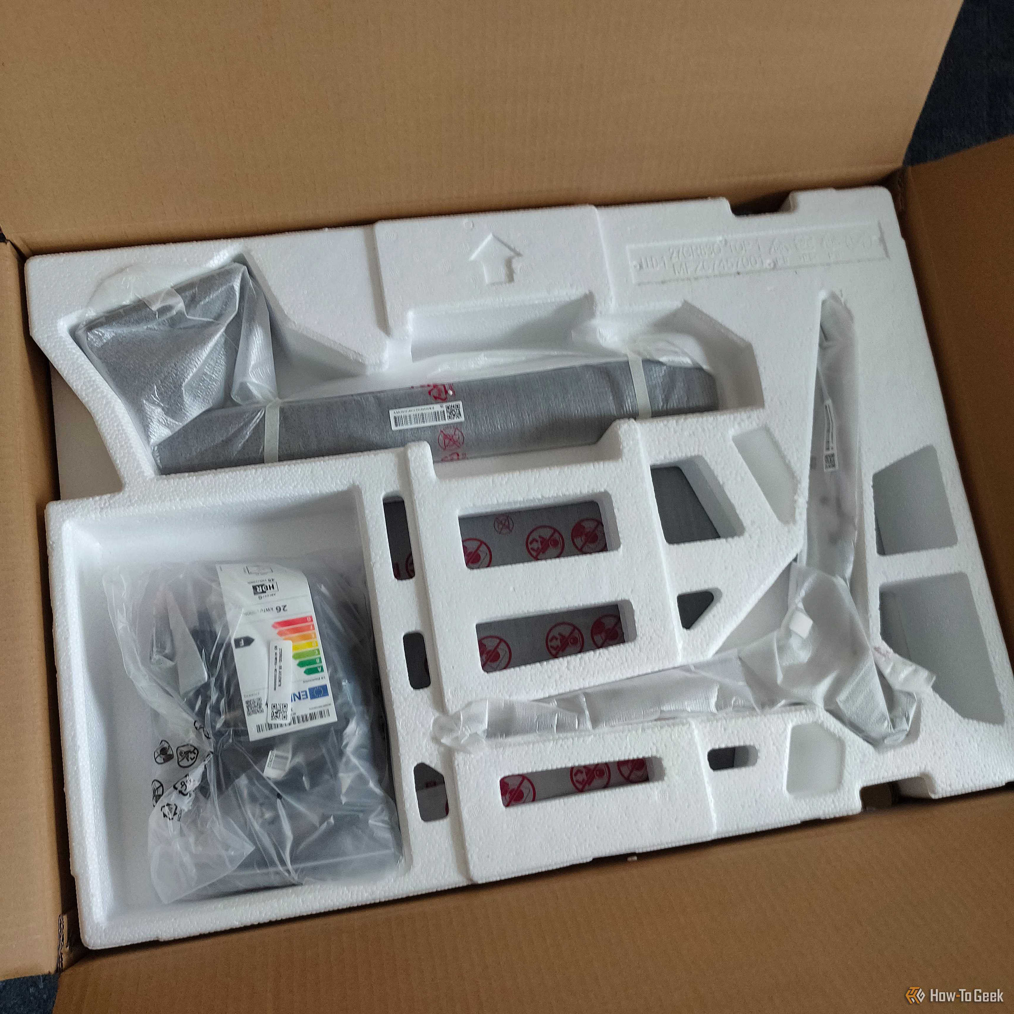 A monitor inside of a cardboard box.