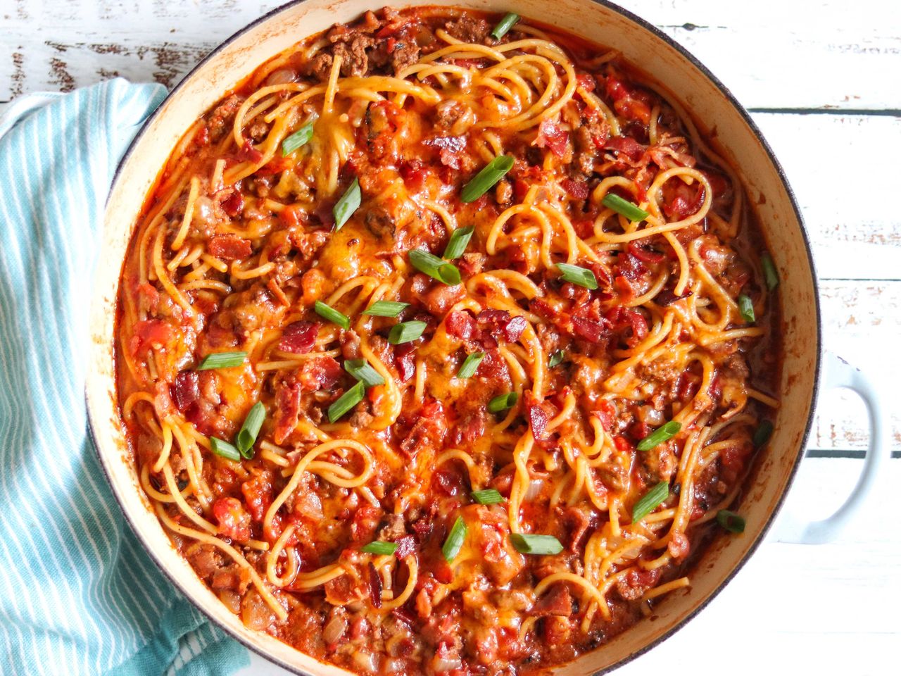 cowboy spaghetti in tomato sauce topped with scallions