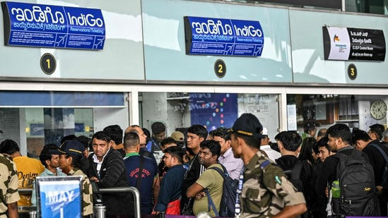 IndiGo flights cancelled live: Passengers wait outside the IndiGo Airlines kiosk at the Kempegowda International Airport in Bengaluru.