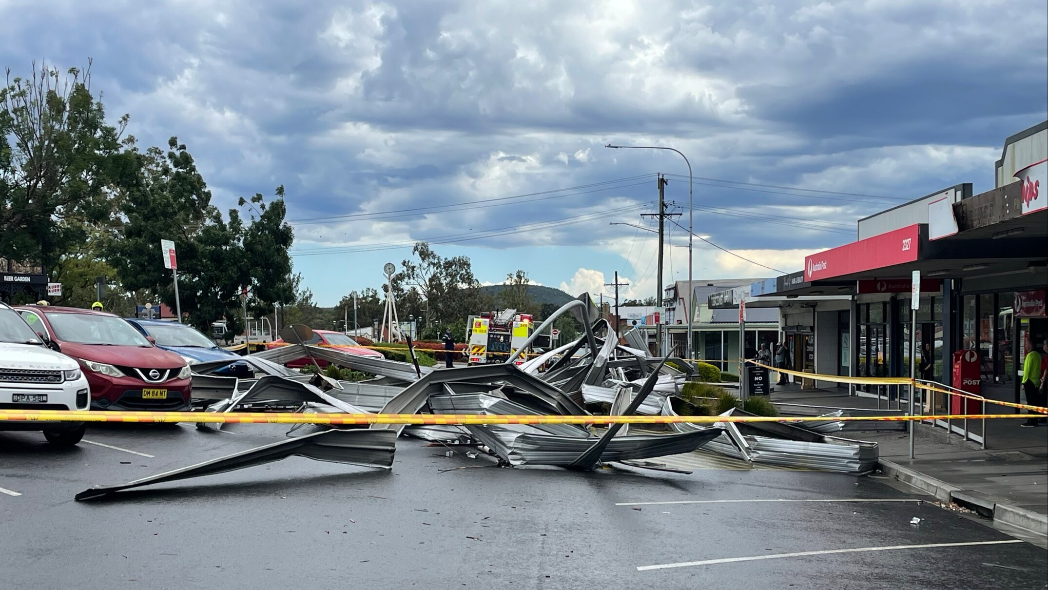 Man killed and 117,000 without power as storms lash Sydney and western NSW
