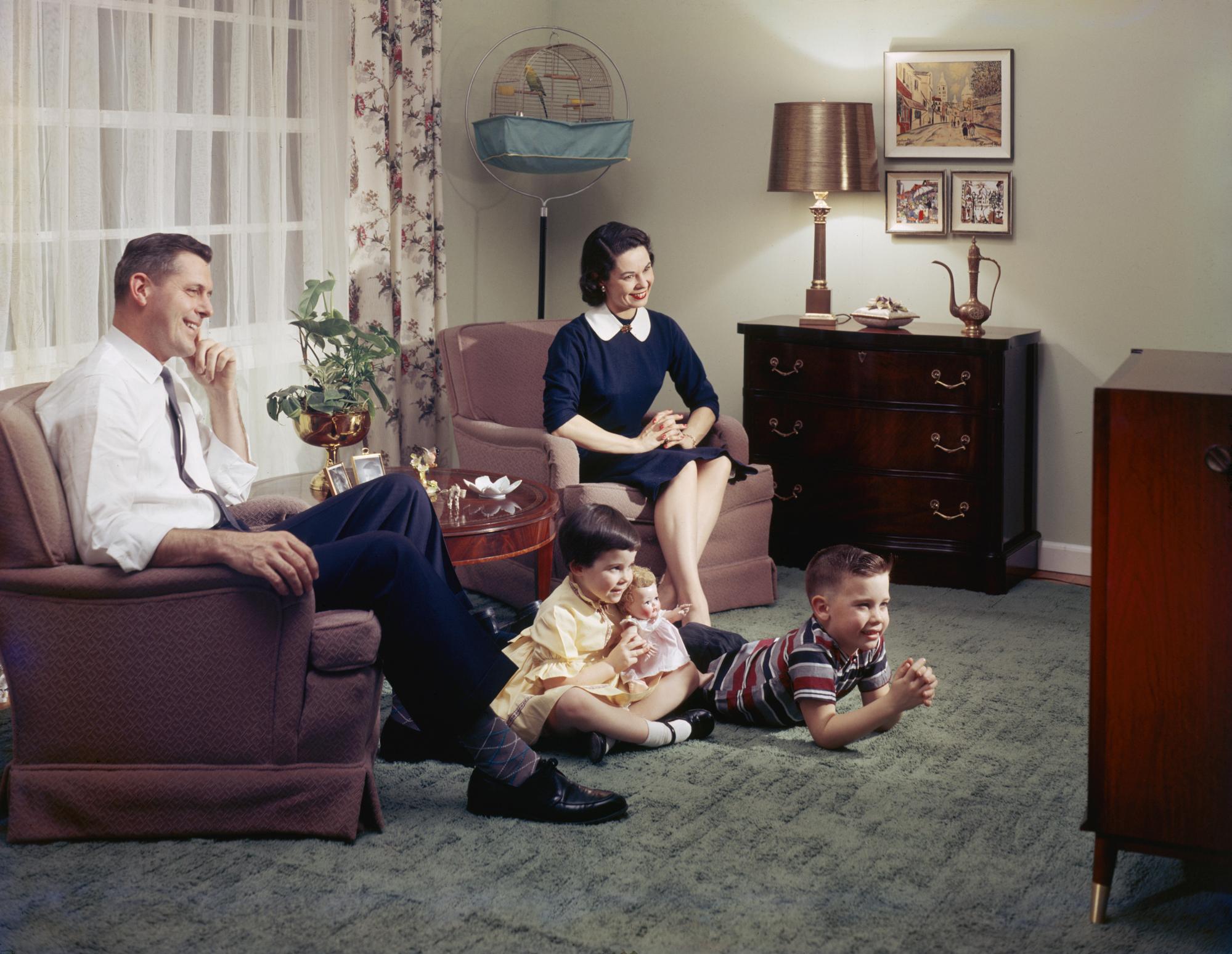 A family spending quality time together in their lounge, 1957. Photograph: Harold M Lambert/Getty Images