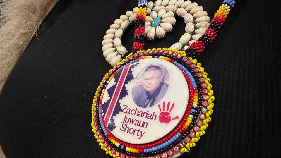 Vangie Randall-Shorty wears a button in memory of her son Zachariah Shorty in Bernalillo, New Mexico, on November 24, 2025. - Susan Montoya Bryan/AP