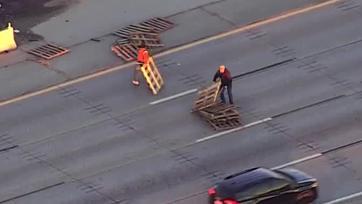WATCH: Drivers get out cars to move pile of pallets left in middle of I-44