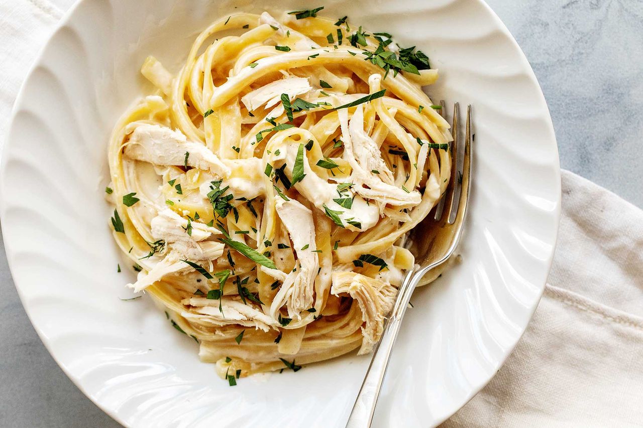 A plate of chicken alfredo, ready to serve and eat