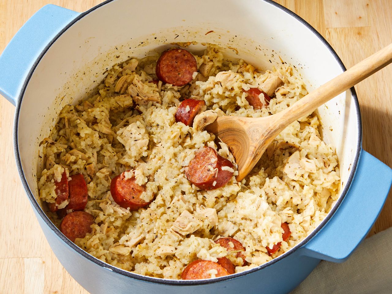 close up on a pot of chicken bog with a spoon resting inside